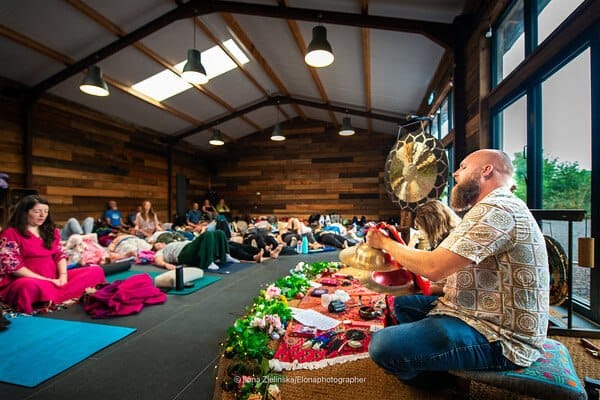 Ceremonial fire offering with flowers at an outdoor gathering